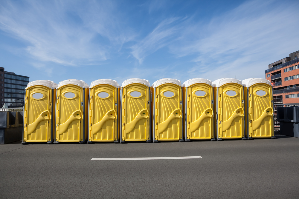 standard portable toilets lined up in Jasper