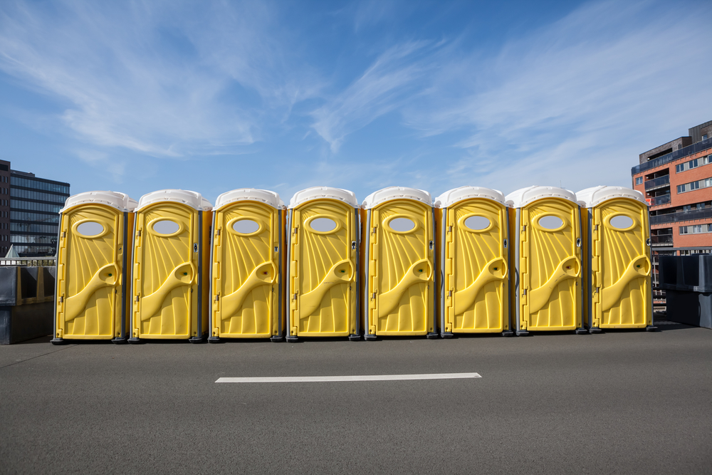 standard portable toilets lined up in Dayton